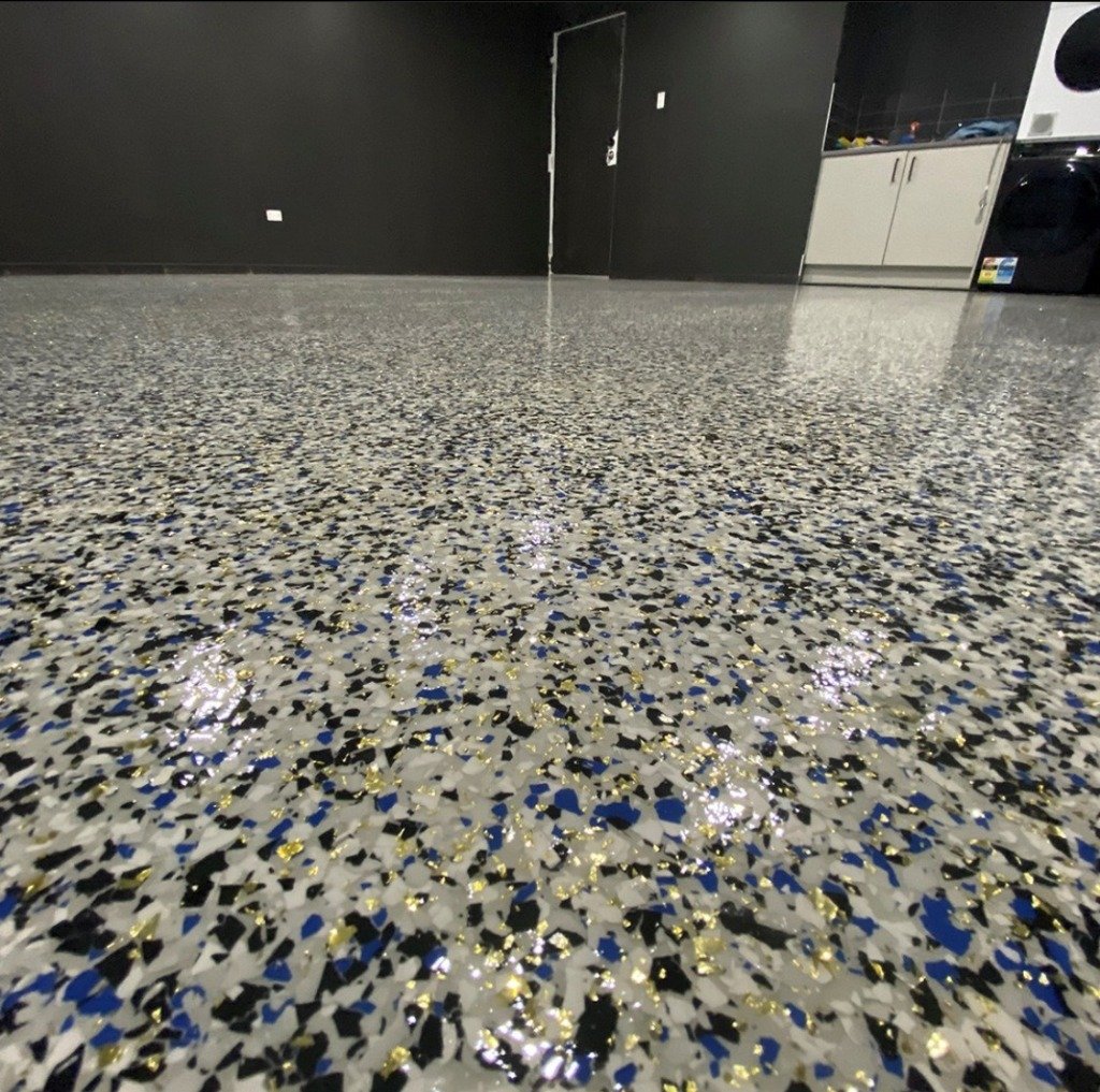 Premium vinyl flake floor with gold accents in garage